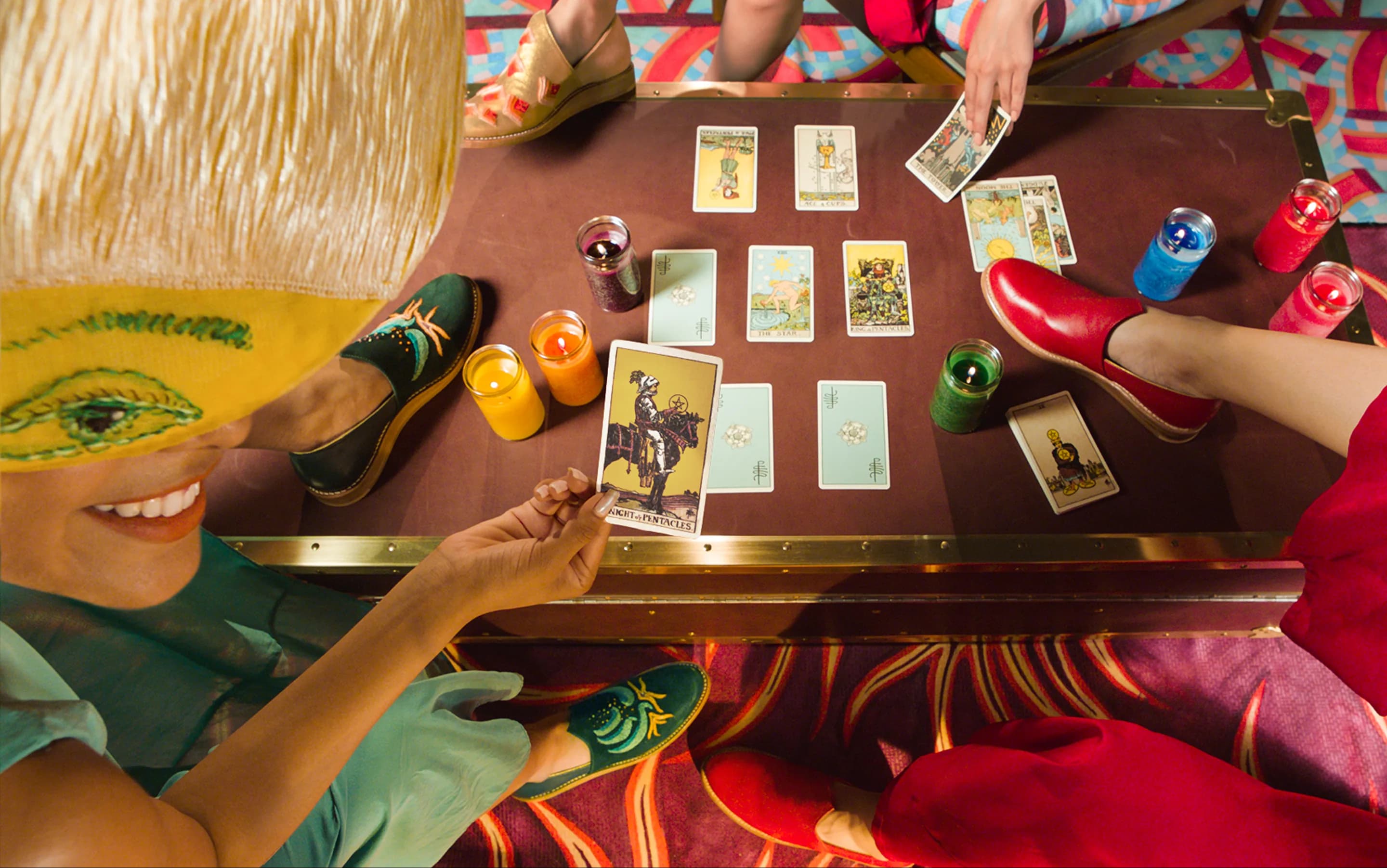Bathke Bespoke: group tarot-card reading with several people wearing the loafers around a table