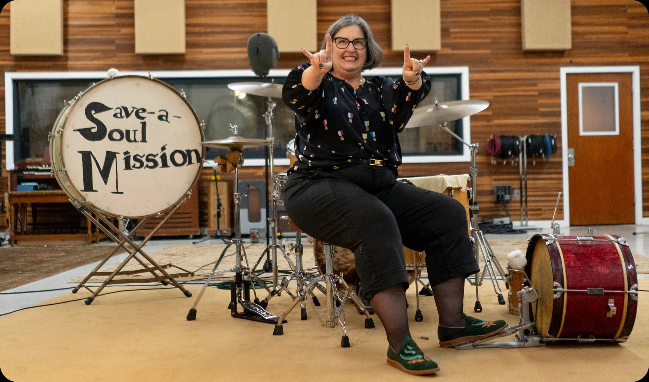 Bathke Bespoke: a woman wearing the shoes drumming in a recording studio