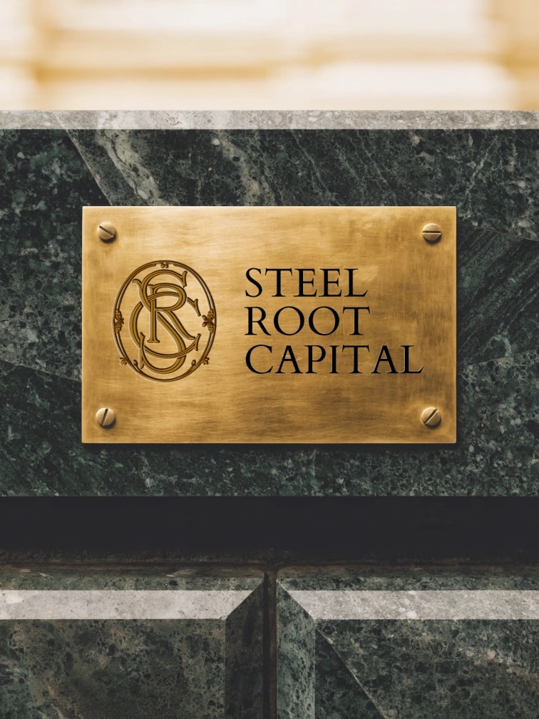 Steel Root Capital strip card: the engraved brass plaque on stone